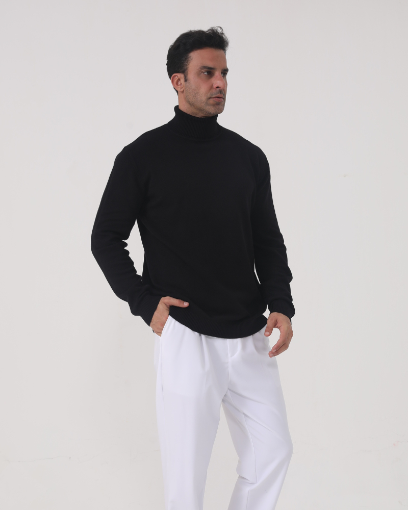 Man wearing merino wool turtleneck sweater in Black – Sorrento, front view, refined tailored fit.