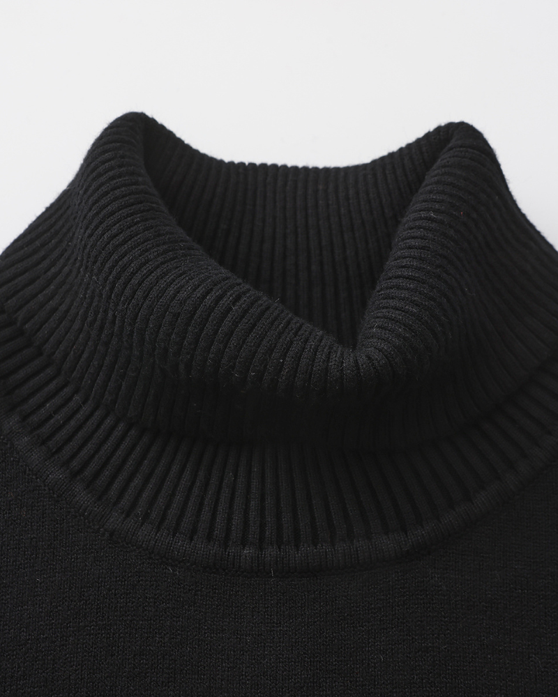 Man wearing merino wool turtleneck sweater in Black – Sorrento, front view, refined tailored fit.